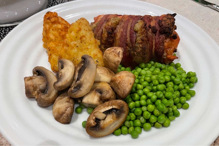 Air fried stuffed chicken and bacon. Chicken stuffed with breadcrumbs, wrapped in bacon and cooked air fryer.